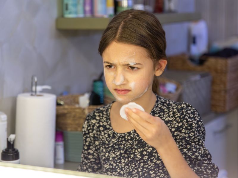 Una chica se seca el cabello con un secador de cabello en el concepto de higiene del bano